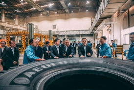 Several men touching a giant tire