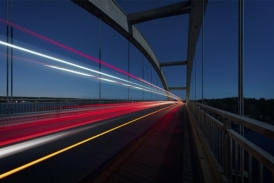 Bridge with lights of cars at speed