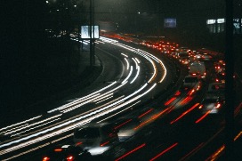 Great highway at night illuminated by car lights