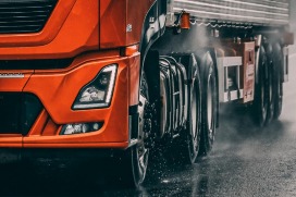 Red truck on wet road